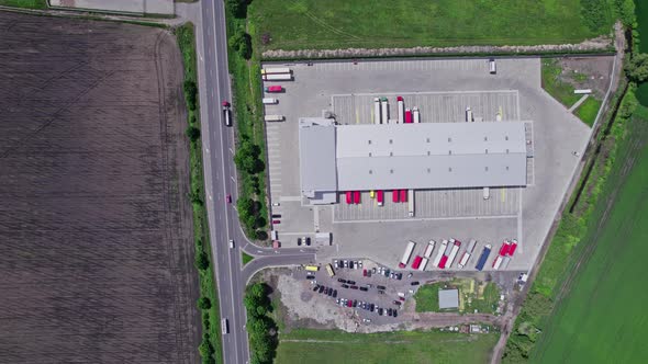 Aerial Top View of a of Semitrailer Truck Traveling Through the Parking