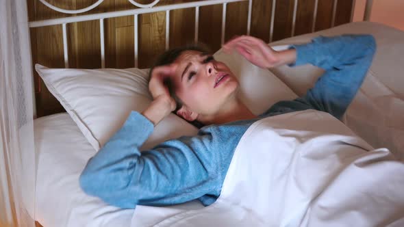 Frustrated Tense Woman Lying in Bed Screaming in Anger