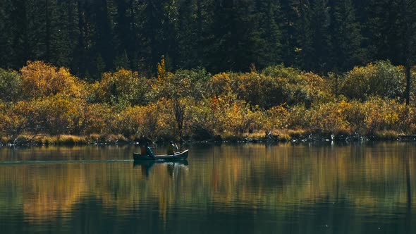 Canoe on lake rowing by in autumn close up