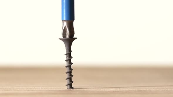 Man Using a Drill and Screwdriver on Wooden Plate, White, Slow Motion, Close Up