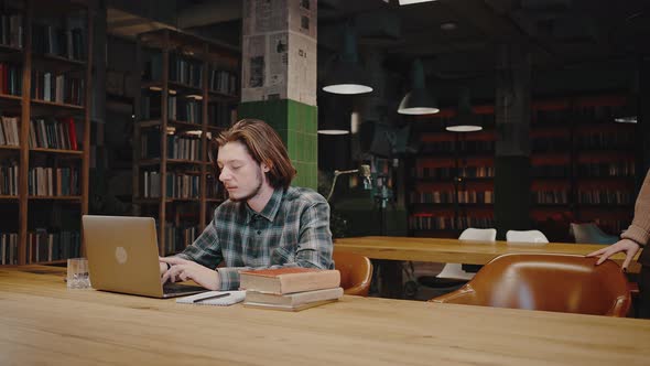 Young Woman Student Coming to Library and Greeting Her Guy Groupmate Giving High Five to Each Other