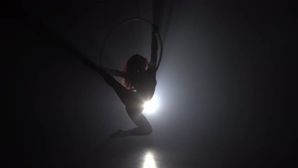 Aerial Acrobat in the Ring. A Young Girl Performs the Acrobatic Elements in the Air Ring