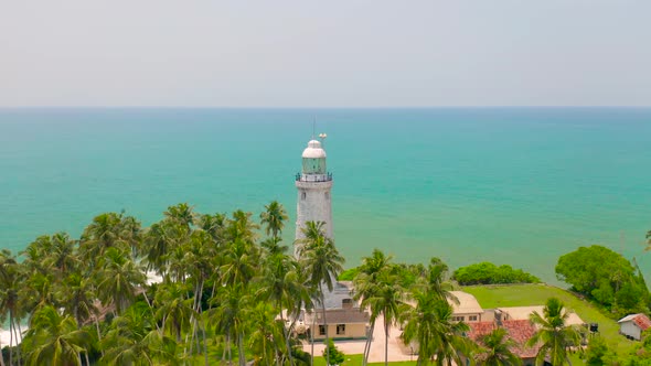 White Lighthouse on the Tropical Island the Indian Ocean