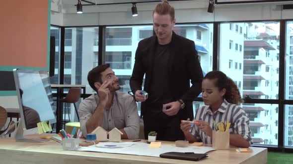 Creative Business People Group Having Conversation at Office Desk in Workplace