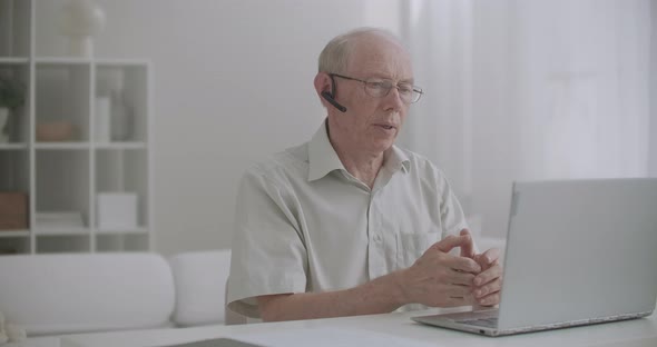 Old Teacher Is Lecturing Online, Staying Home and Communicating with Pupils By Internet