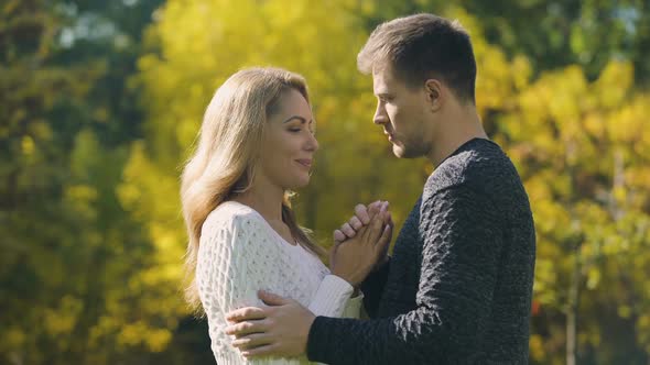 Couple Holding and Warming Hands in Cold Autumn Day, Taking Care of Beloved