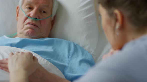 Elderly Hospital Patient Having Talk with Daughter