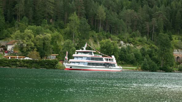 Austrian tourist ship docking at pier on Achensee Lake during holidays.Static wide shot.