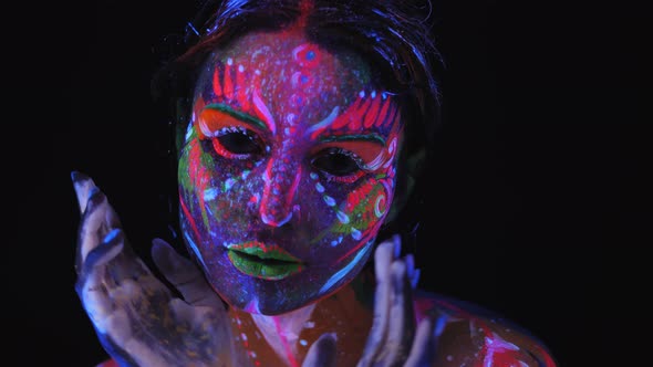 Portrait of Girl with a UV Pattern on Her Face She Slowly Moves Her Hands