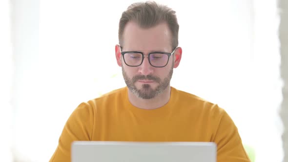 Portrait of Man Working on Laptop