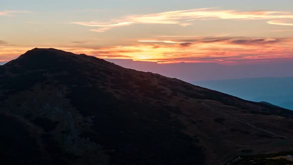 Silhouette of a mountain at sunset, 4K