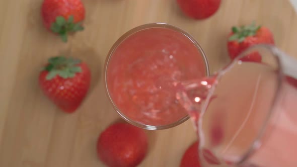 Fresh Delicious Strawberry Juice Pours Into a Glass
