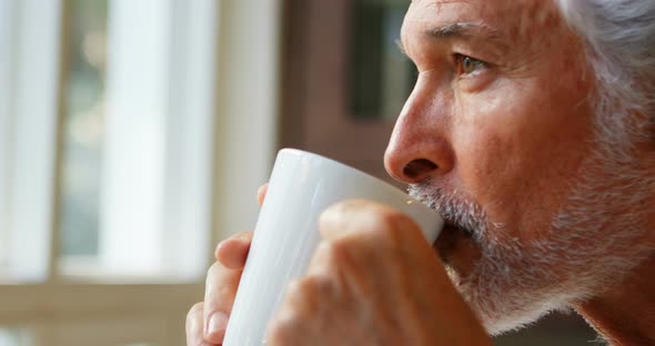 Senior man having coffee at home 4k