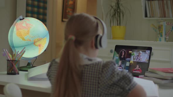 Schoolgirl Learning with Online School Teacher and Pupils on Laptop Screen