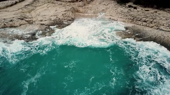 Aerial view of cliffs at Losinj coastline with agitated sea, Croatia.