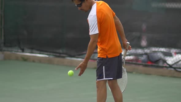 Tennis player preparing to serve.