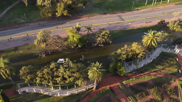 aerial view of the palermo lakes in buenos aires with a white boat followed by many ducks