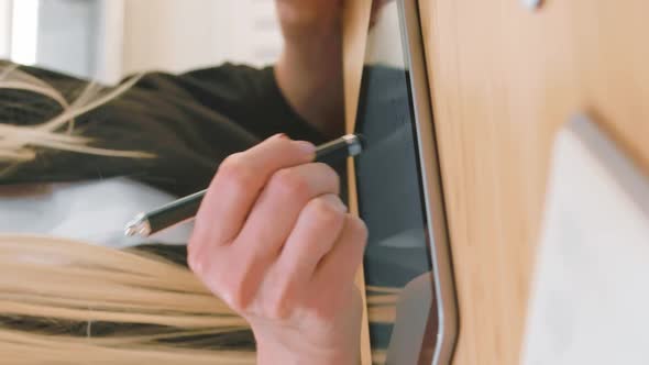 Business Women Working on Tablet in Office. Attractive Blond Female with Long Hair in Elegant Suit