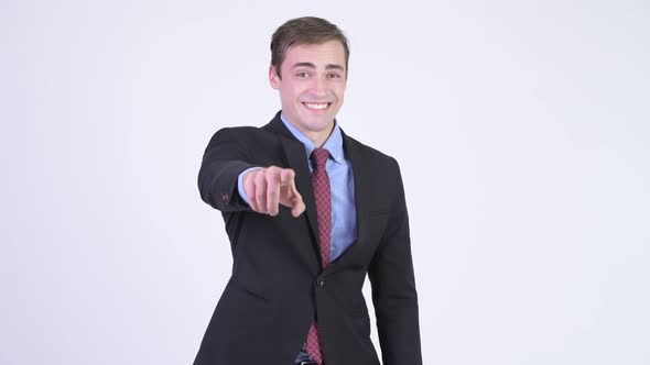 Young Happy Handsome Businessman Pointing To Camera