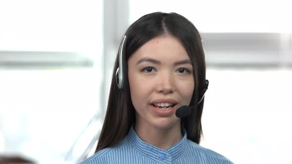Caucasian Young Asian Girl Talking By Headset.