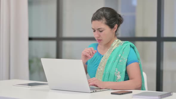 Indian Woman Coughing While Using Laptop in Office