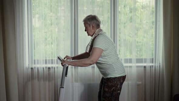Mature Woman Runs on a Treadmill