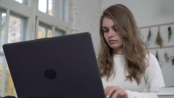 Attractive Woman at Home with a Laptop