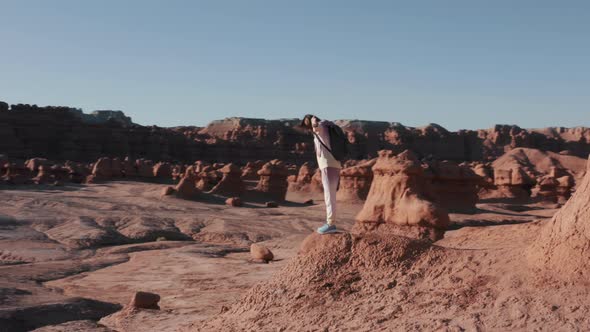 Happy Tourist Enjoying Incredible View of Red Planet Woman in Goblin Valley