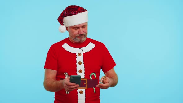 Man in Christmas Tshirt Using Credit Bank Card Smartphone While Transferring Money Shopping Online