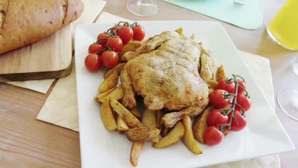 Roasted chicken with cherry tomato in tray