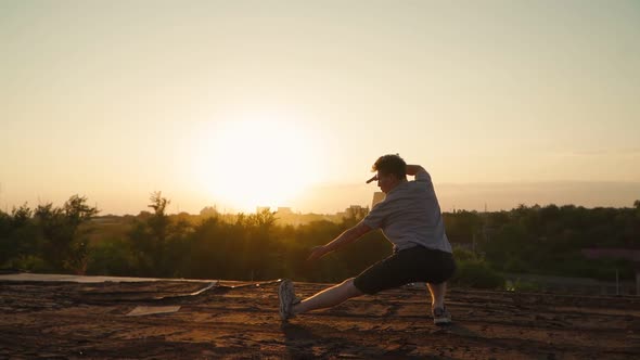 Silhouette of a man practicing martial arts on the background of a beautiful sunset.