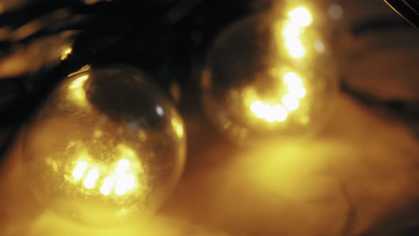 Close Up of Christmas Garland with Transparent Light Bulbs in Stock Warehouse