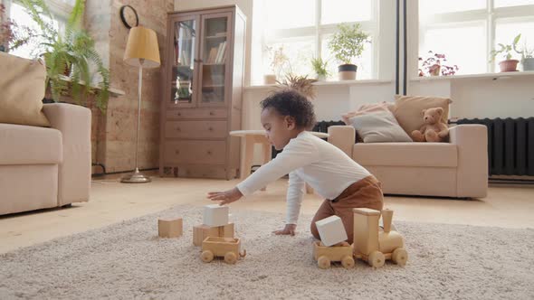 Cute Toddler Boy Playing with Toys alt