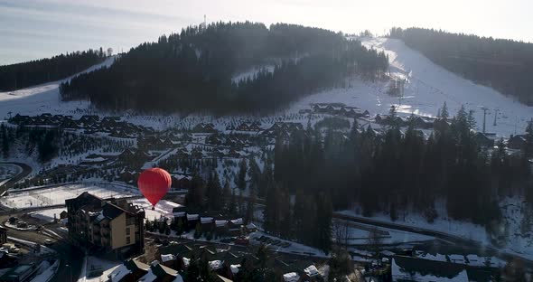 Aerial View of the Ski Resort in Mountains at Winter. Balloon in the Sky Near the Mountain