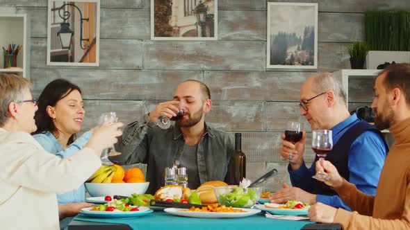 Multigenerational Family Clinking Wine Glasses at Sunday Dinner