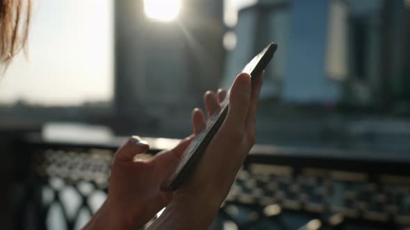 Woman with Smartphone in Hands Outdoors Closeup View of Cellphone in Hands of Lady