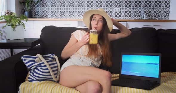 Woman Bored on Couch at Home in White Room Blows Bubbles Into Juice Vacation Dreaming