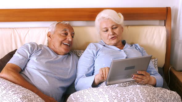 Senior couple using digital tablet