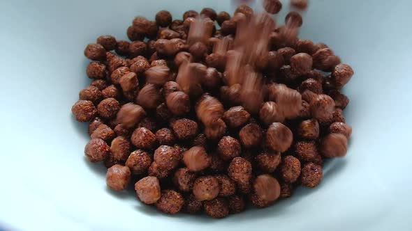 Chocolate Corn Balls Are Falling Into The Plate