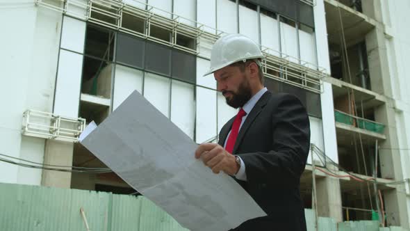 An Engineer Developer at a Construction Site Checks on the Drawings at What Stage the Construction