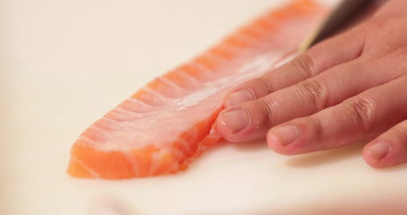 Cutting Excess Meat Of Fresh Salmon Fillet - Sushi Making - close up, slow motion