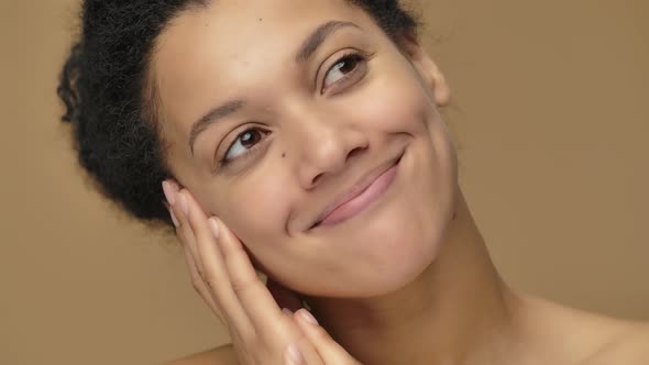 Beauty Portrait of Young African American Woman is Dreaming of Something Pleasant and Smiling