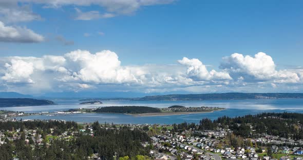 Aerial shot of Whidbey Island's Oak Harbor surrounded by clouds on a warm summer's day.