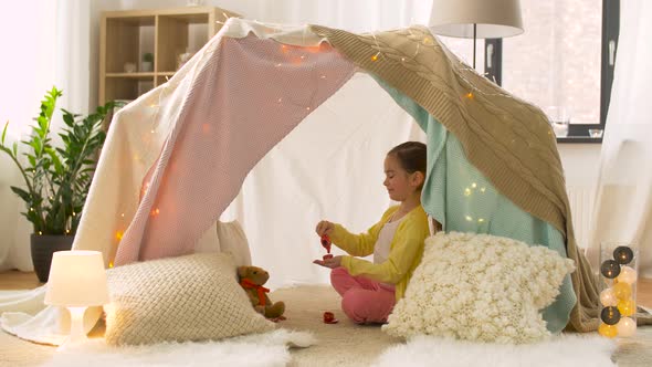 Happy Girl in Kids Tent Playing Tea Party at Home