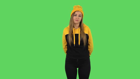 Modern Girl in Yellow Hat Is Waiting and Yawning with Boredom. Green Screen