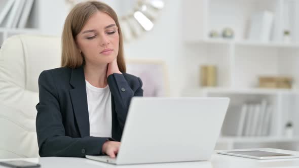 Tired Businesswoman Having Neck Pain in Office 