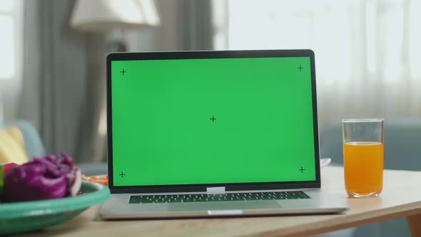 Close Up Of Green Screen Laptop On The Table With Healthy Food