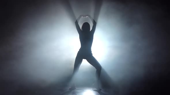 Silhouette Leggy Girl Dancing in Smoky Studio. Slow Motion