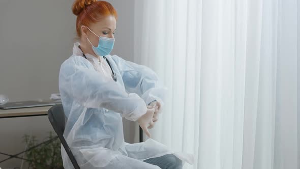 Portrait of Concentrated Serious Caucasian Woman in Doctor Uniform and Covid19 Face Mask Adjusting