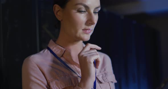 Caucasian female it technician using tablet checking computer server